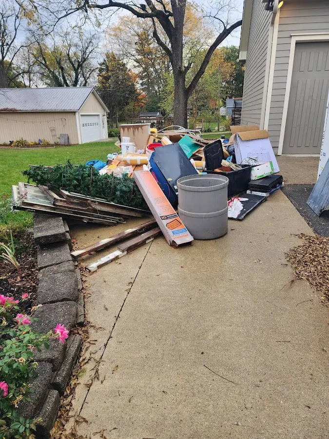 Dumpster being loaded with debris for Residential Dumpster Rental in Greenfield